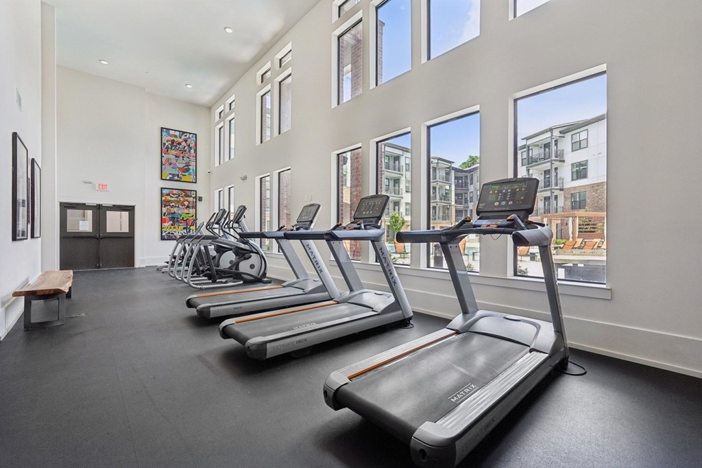 A gym with treadmills and ellipticals